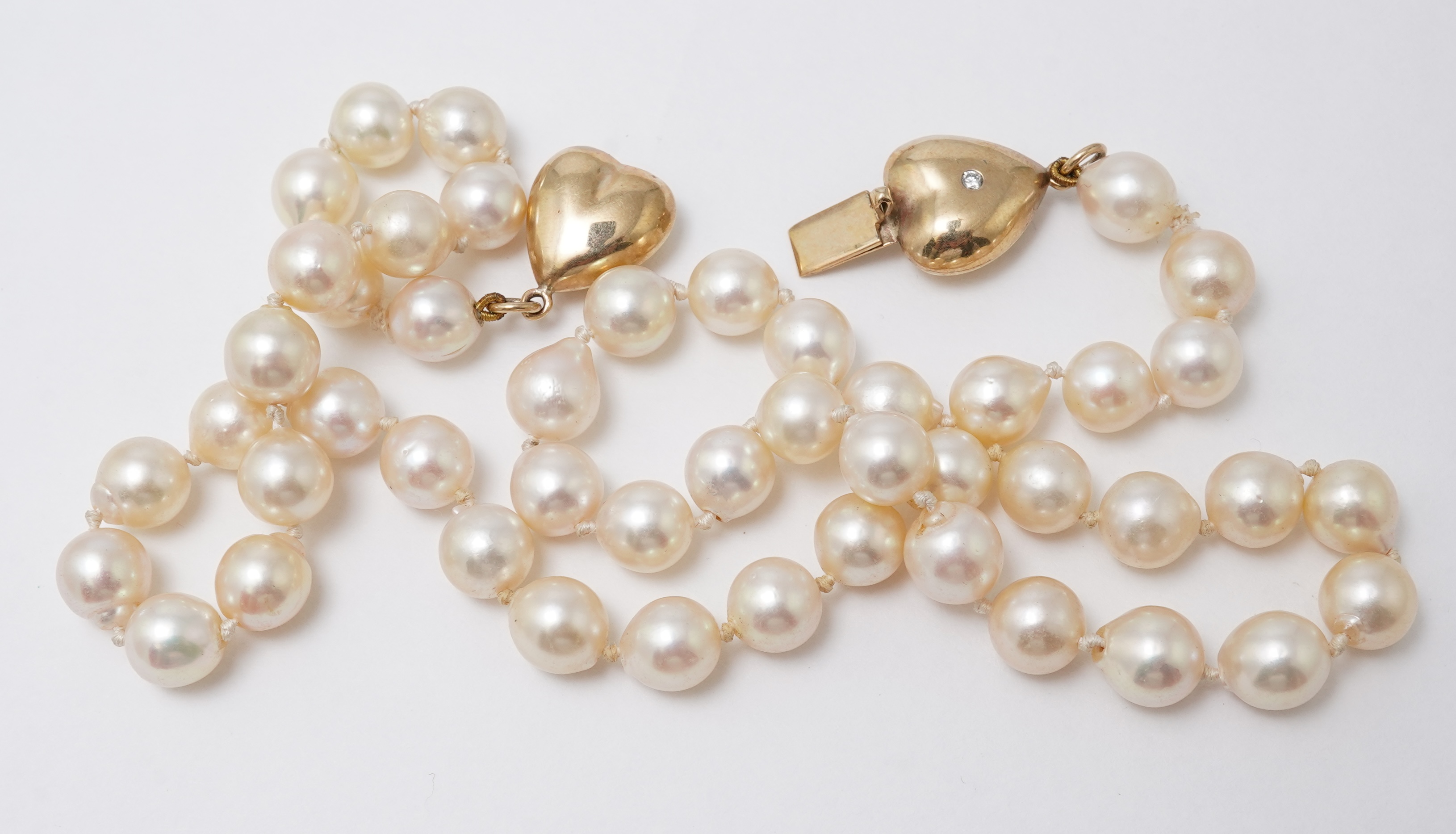 A cultured pearl, gold and diamond necklace
